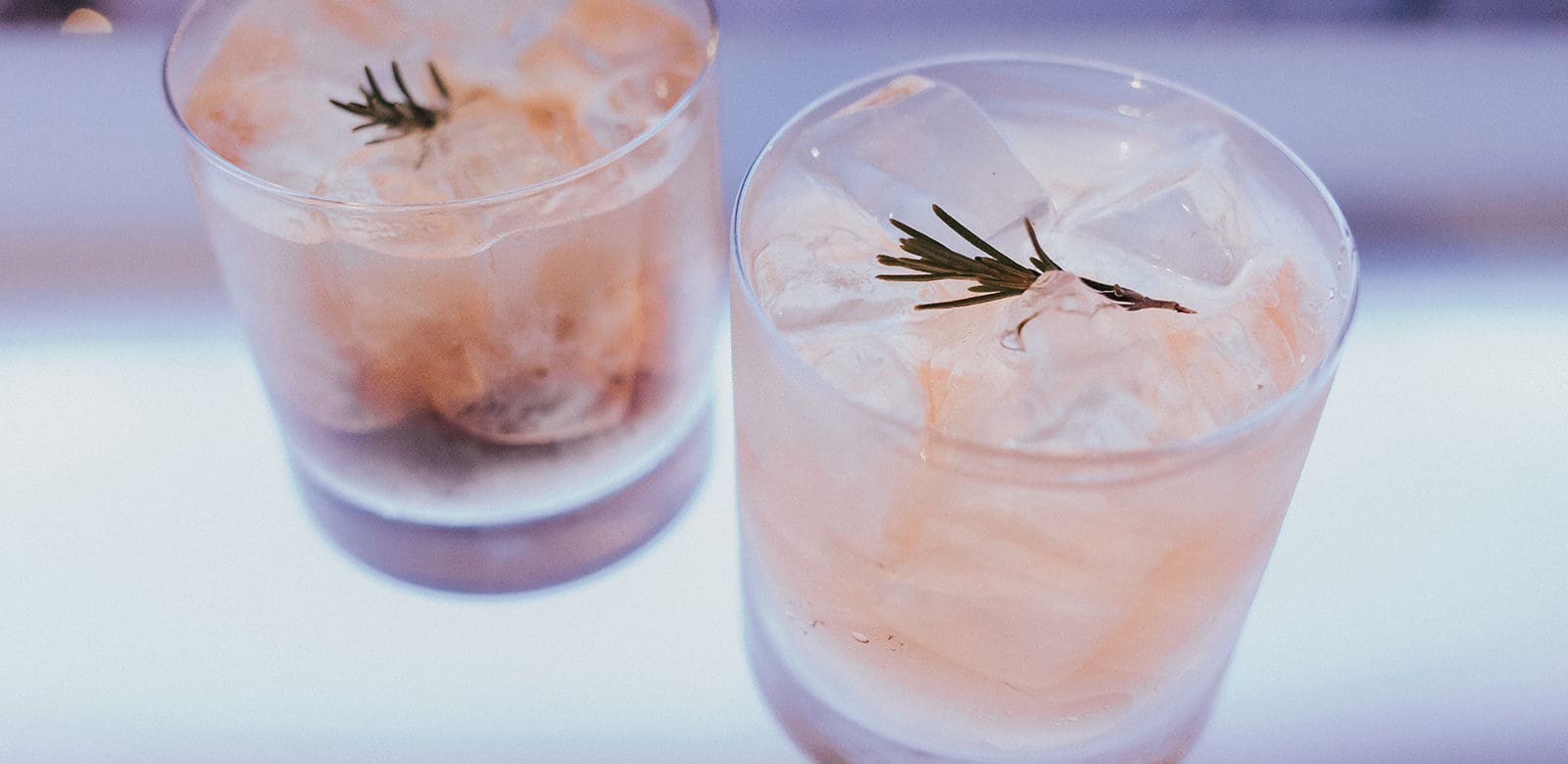 whiskey rose cocktail recipe with rosemary, lemon, and sparkling apple soda